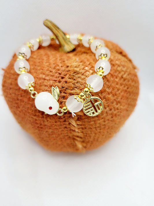 Faux Pearl like stones gold and bunny bracelet